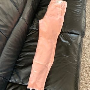 Baby pink skinny jeans with zippers on ankles